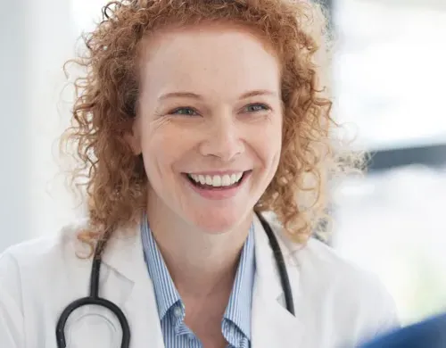 Women's health nurse practitioner WHNP smiling with patient during consultation